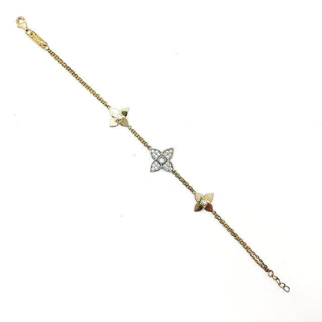 Pulsera dorada con flores